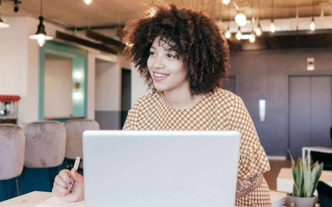woman working on laptop in a cafe