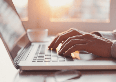 hands typing on a laptop