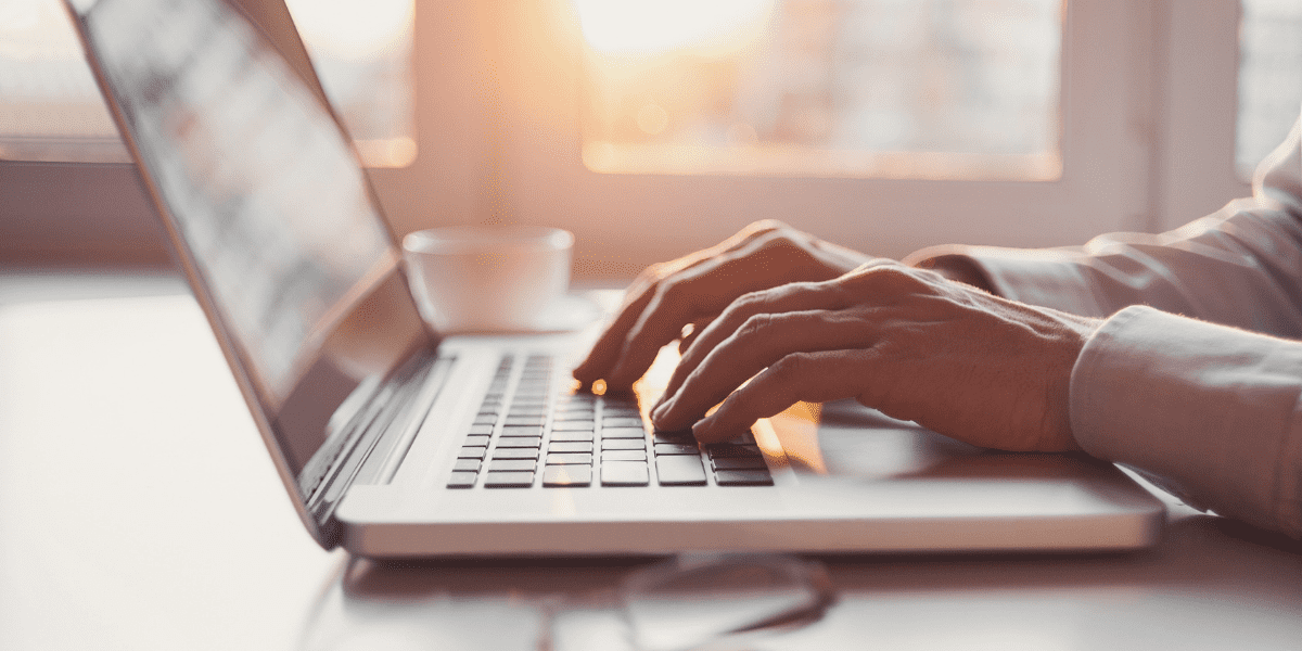 hands typing on a laptop