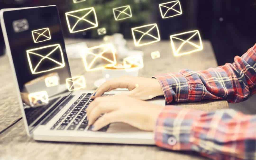 open laptop with floating envelope icons