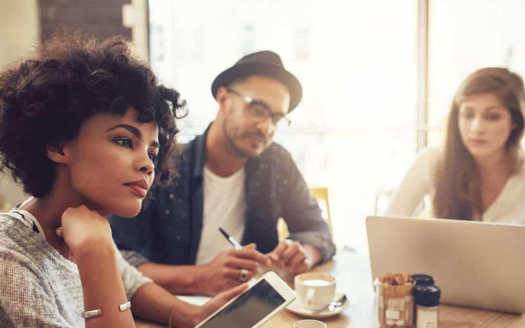 Young people at a cafe with laptop and digital tablet