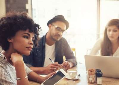 Young people at a cafe with laptop and digital tablet