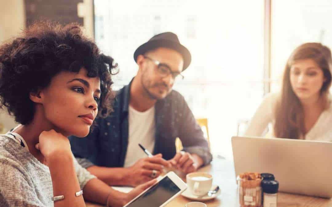 young people in a cafe with a laptop
