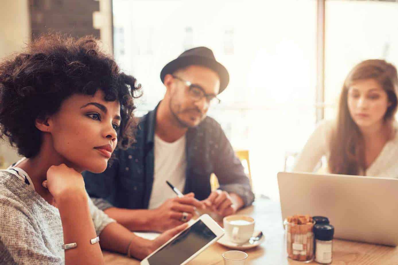 young people in a cafe with a laptop