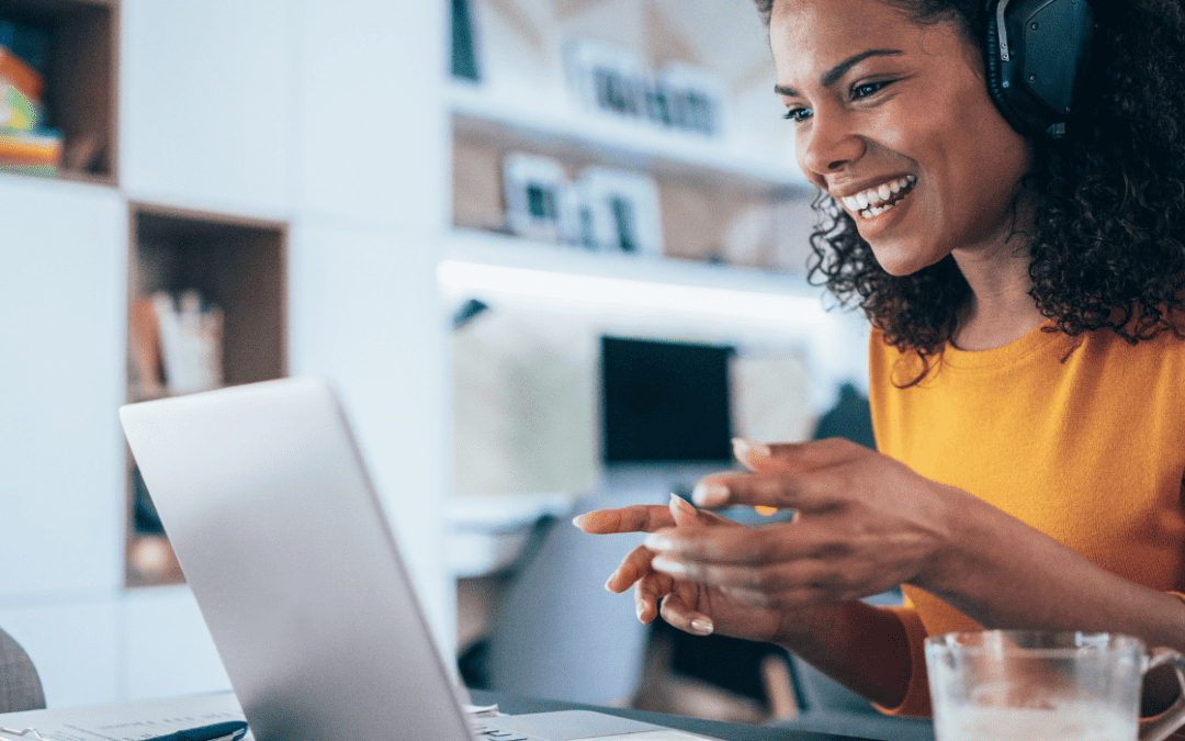 virtual receptionist smiling in front of laptop