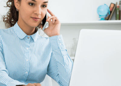 woman on the phone in a very bright office