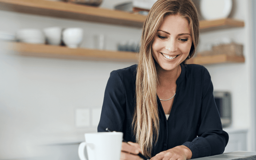 woman working at laptop in her kitchen