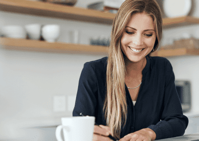 woman working at laptop in her kitchen