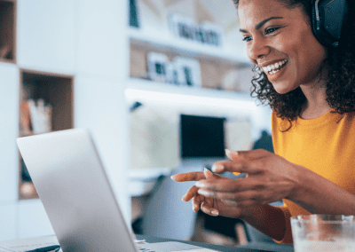 virtual receptionist smiling in front of laptop