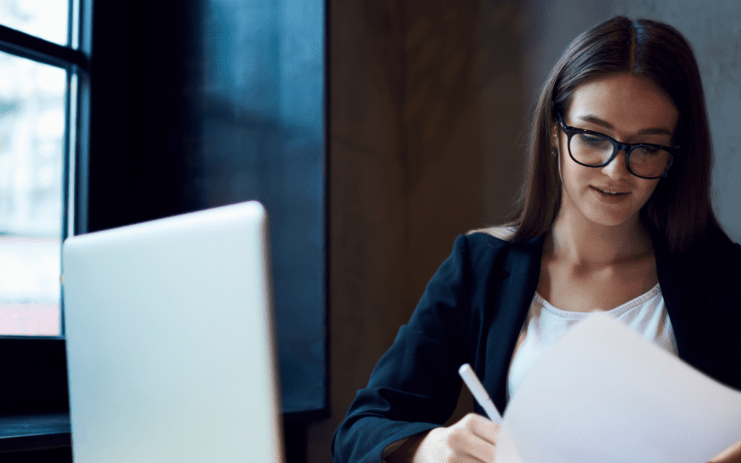 woman working on papers in office