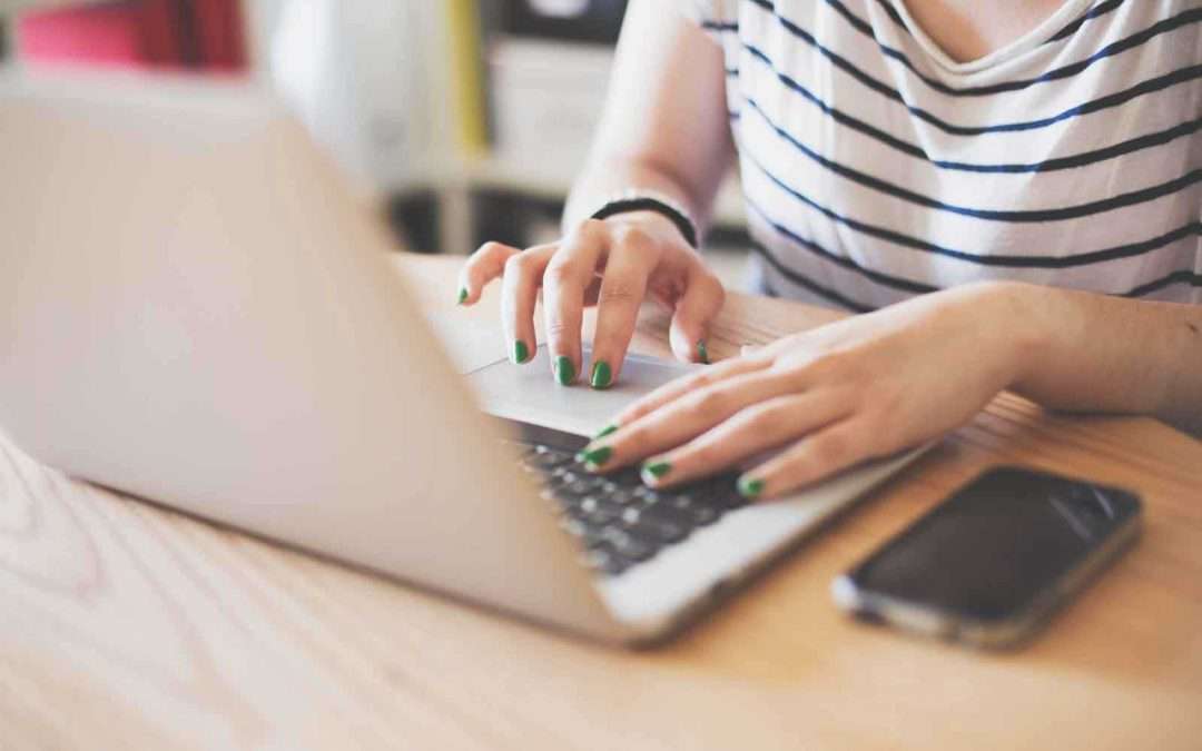 girl with green nails typing on keyboard