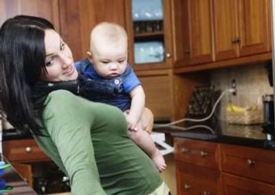 mom in the kitchen holding a baby