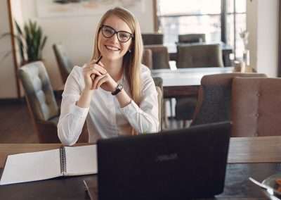 woman in a business office writing in a notebook