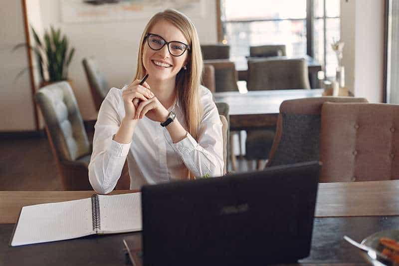 woman in a business office writing in a notebook