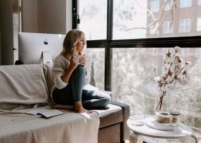 woman sitting on couch having coffee