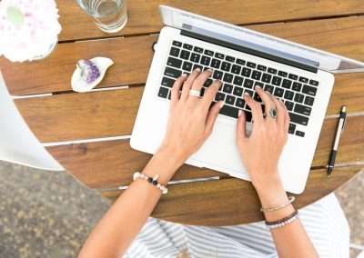 female hands on a laptop outside