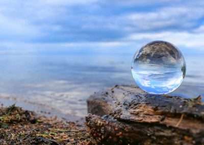 Transparent glass globe at the ocean