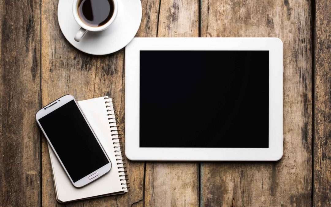 tablet and cellphone on a wooden table