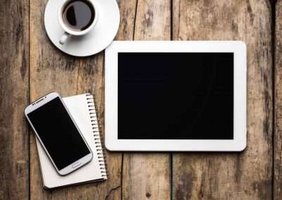 tablet and cellphone on a wooden table