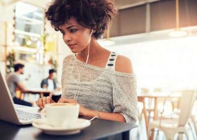 casual woman typing in cafe