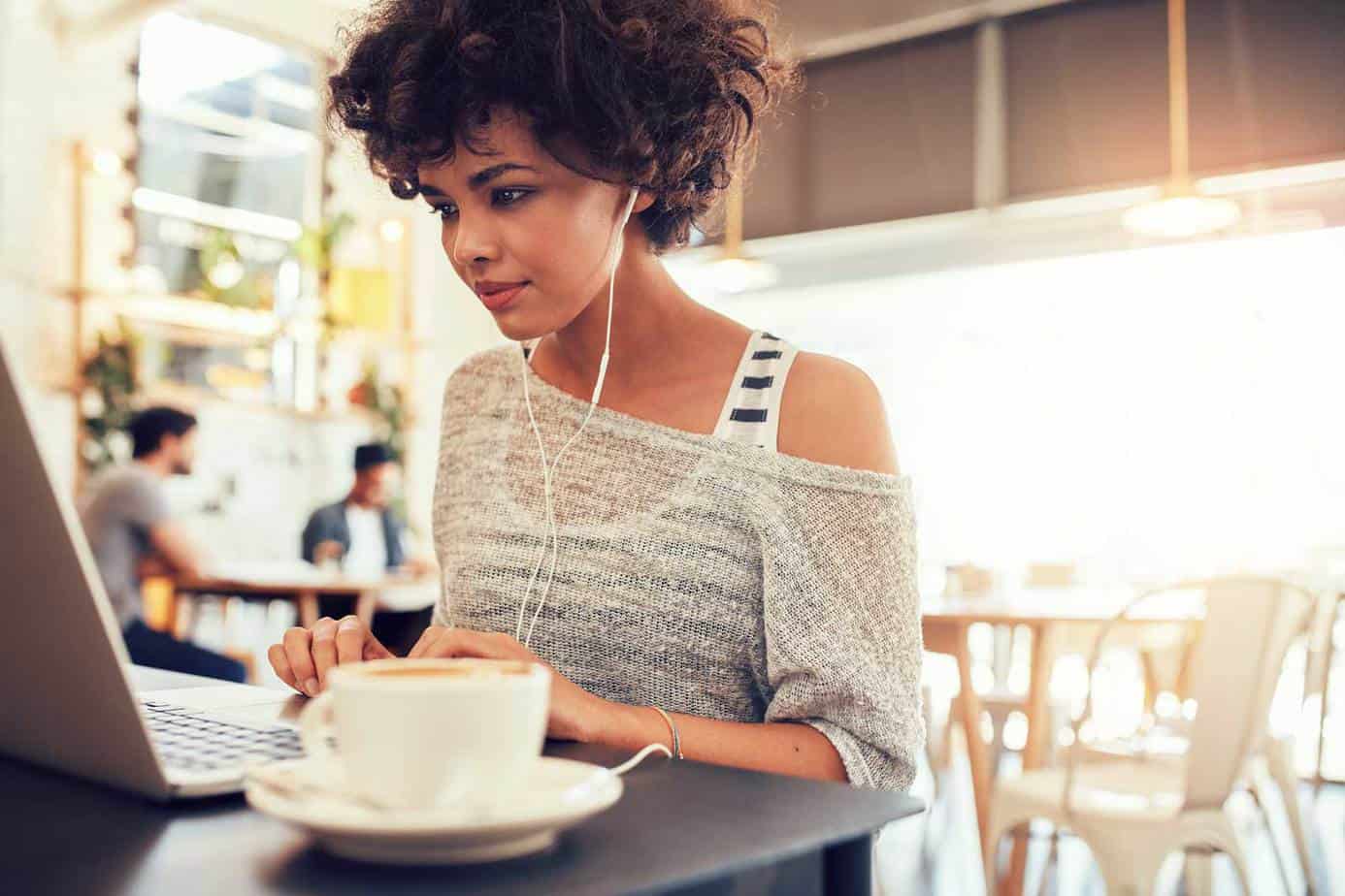 casual woman typing in cafe