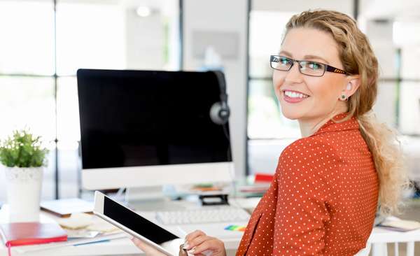 woman in orange shirt at computer