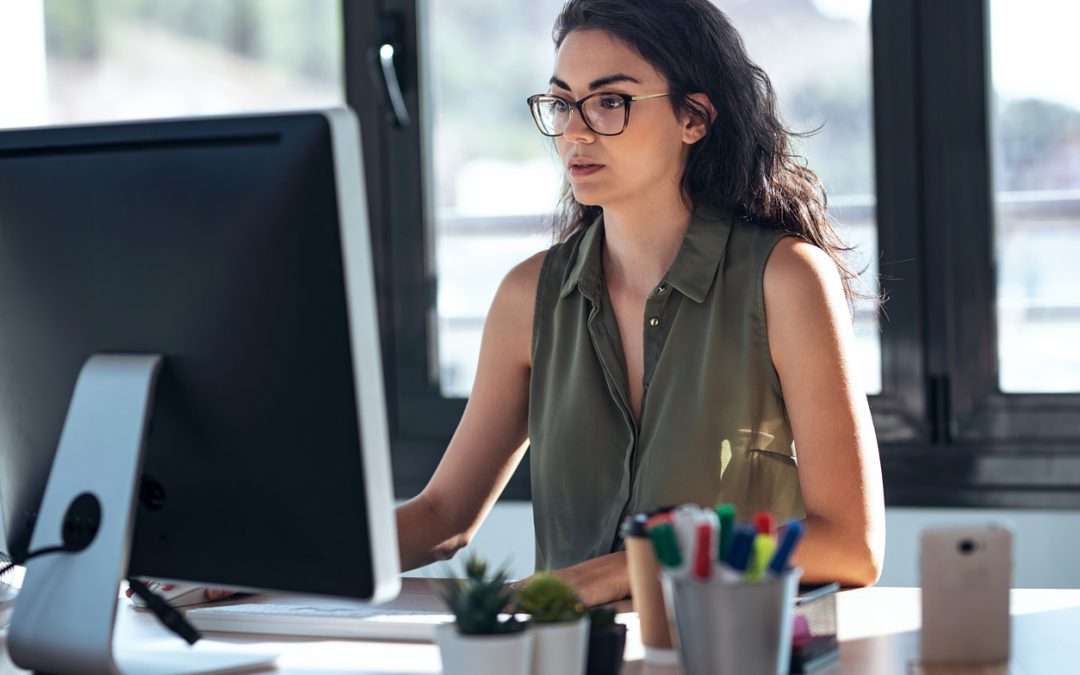 Shot of concentrated young business woman working with computer in the office.