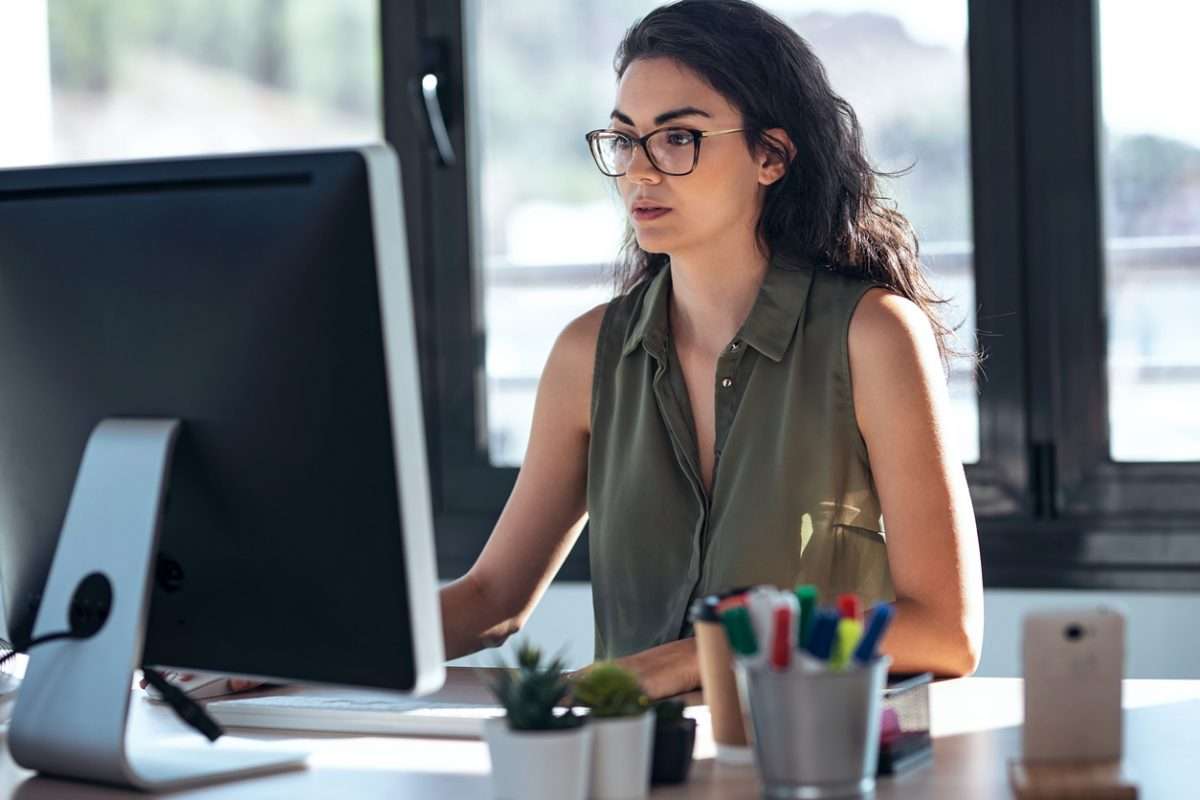 Shot of concentrated young business woman working with computer in the office.