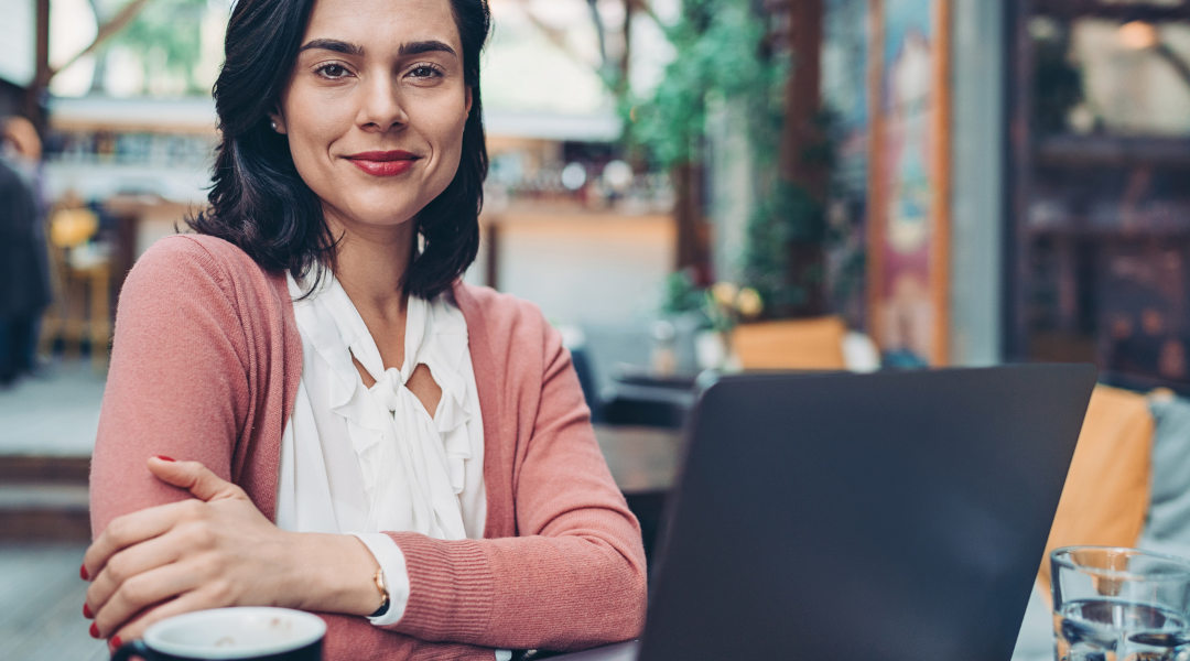 business woman sitting outside working at her laptop