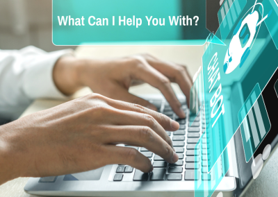 Men’s hands on a laptop with a teal screen showing a white chatbot icon. A speech bubble from the laptop says, “What can I help you with?”