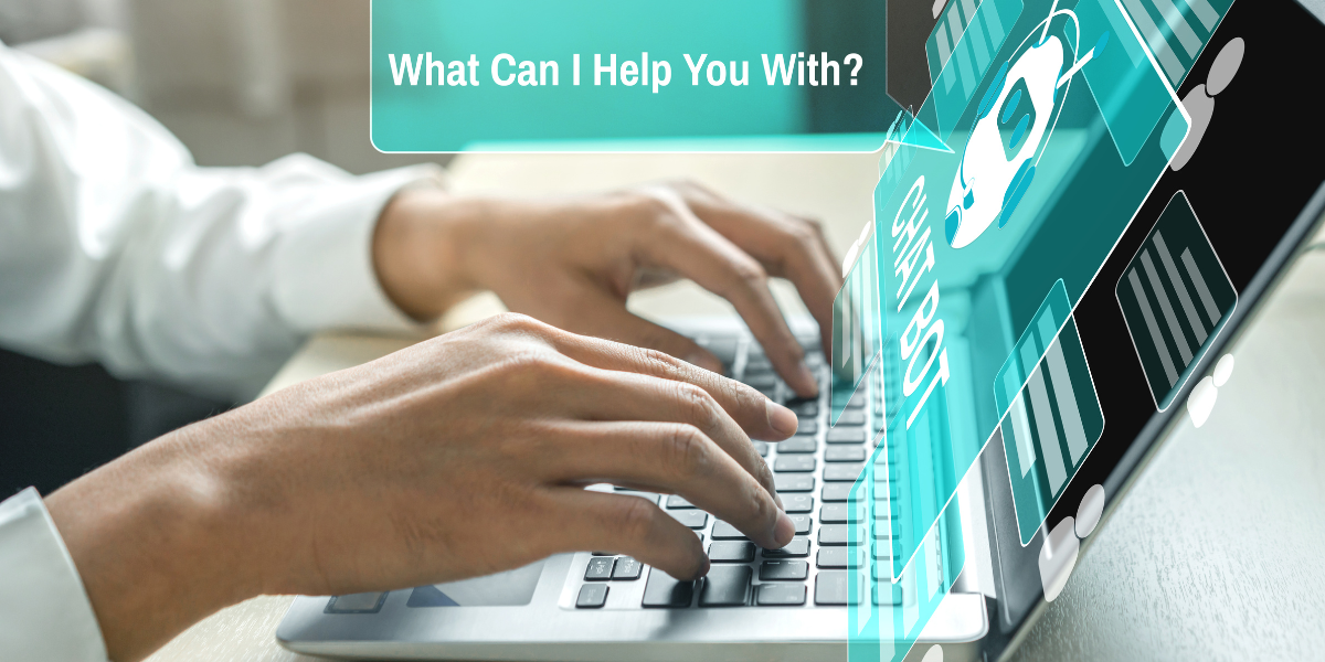 Men’s hands on a laptop with a teal screen showing a white chatbot icon. A speech bubble from the laptop says, “What can I help you with?”