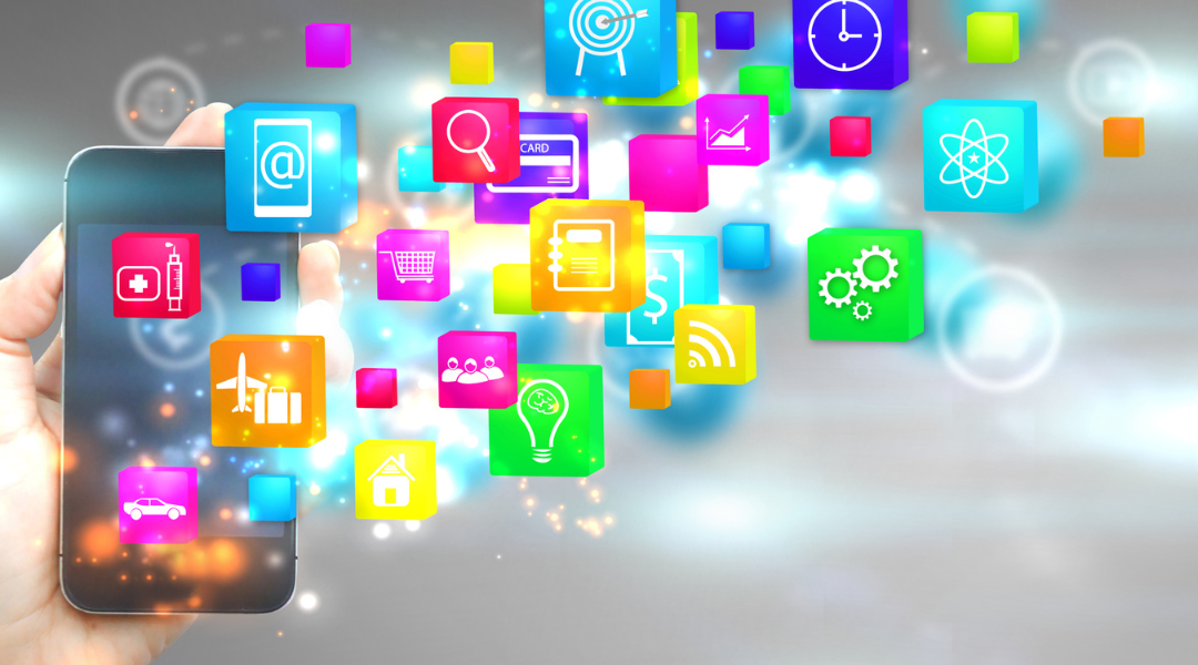 A hand holding a cell phone with numerous neon-colored icons floating around it.