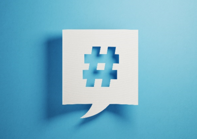 White square speech bubble with a hashtag cutout on a baby blue background.