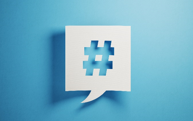 White square speech bubble with a hashtag cutout on a baby blue background.