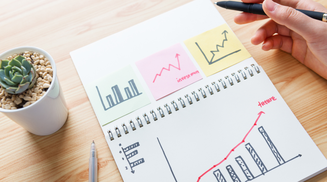 A notebook with 3 sticky notes. The sticky notes have pictures of various graphs and charts.