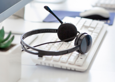 A headset sitting on a computer keyboard.