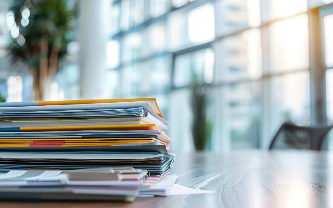 Law office with stacks of paper files and documents in folders on the desk.