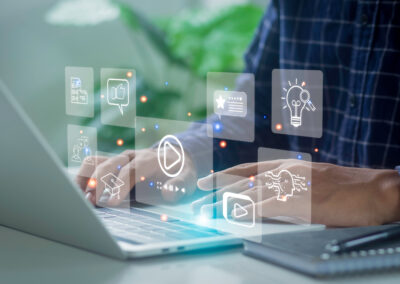 Corporate Law Attorney using a laptop with marketing icons displayed over the image.