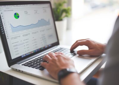 Personal Injury attorney working at laptop showing marketing data and graphs.