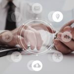 Real Estate Attorney using a laptop and phone, with marketing icons displayed over the image.