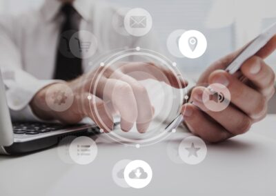 Real Estate Attorney using a laptop and phone, with marketing icons displayed over the image.