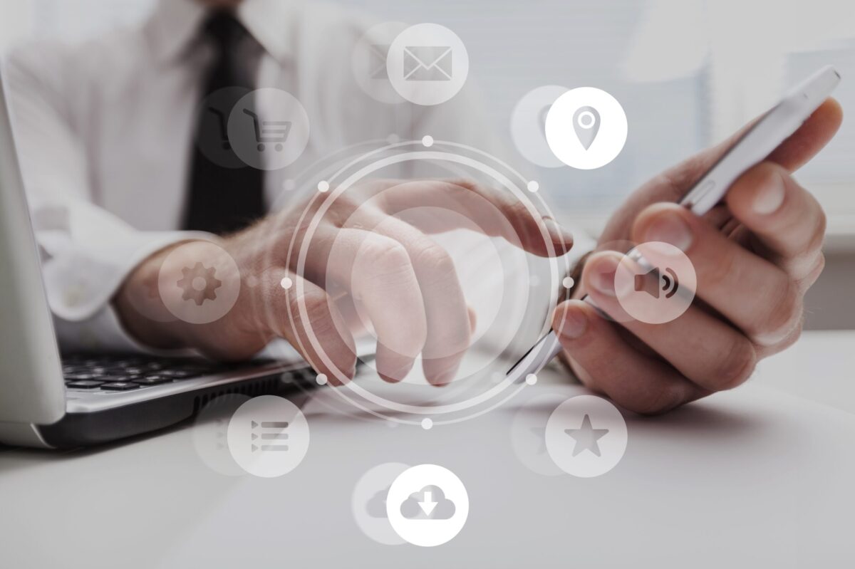 Real Estate Attorney using a laptop and phone, with marketing icons displayed over the image.