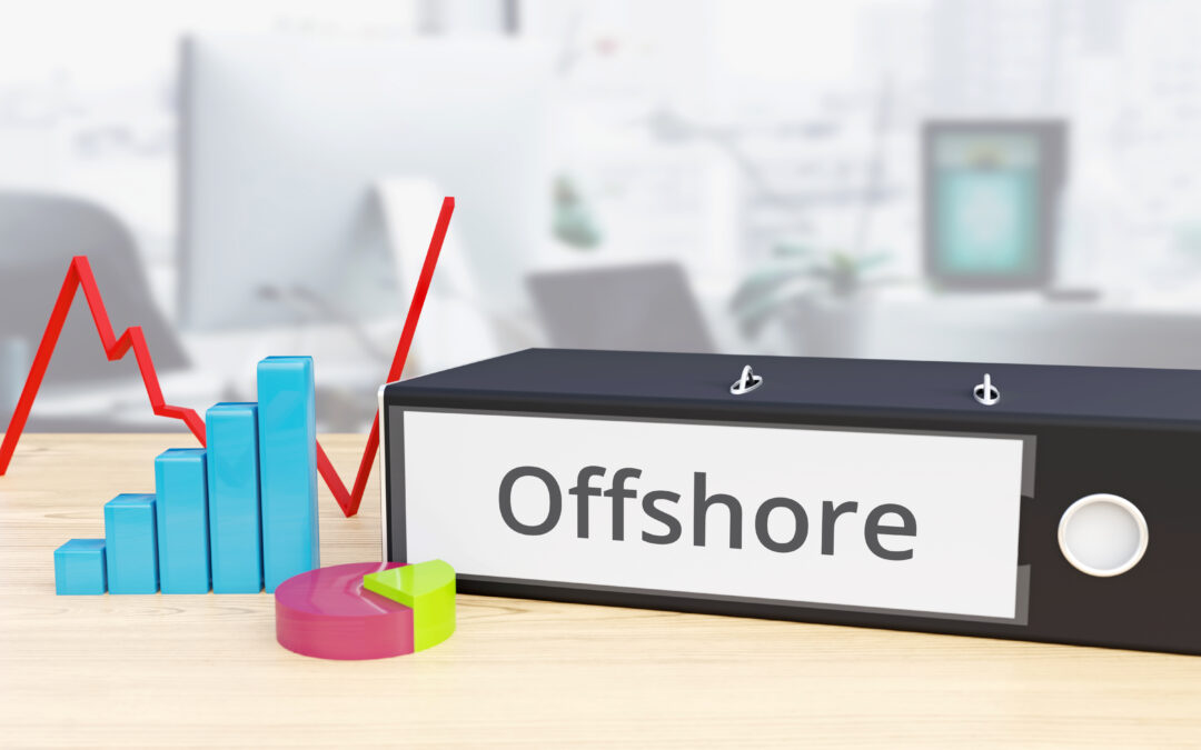 Folder on desk with offshore label beside finance diagrams.