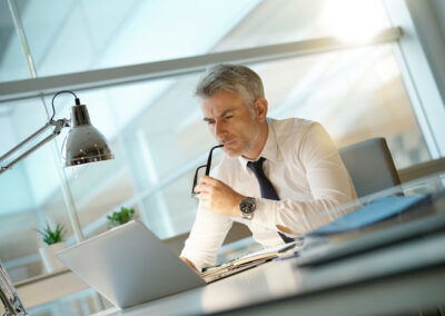 Bankruptcy attorney working on laptop in office, being concerned