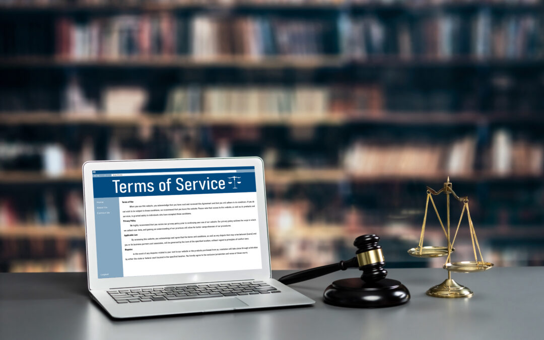 Attorney's office with laptop displaying website terms of service, symbolizing law firm website compliance and security.