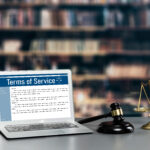 Attorney's office with laptop displaying website terms of service, symbolizing law firm website compliance and security.