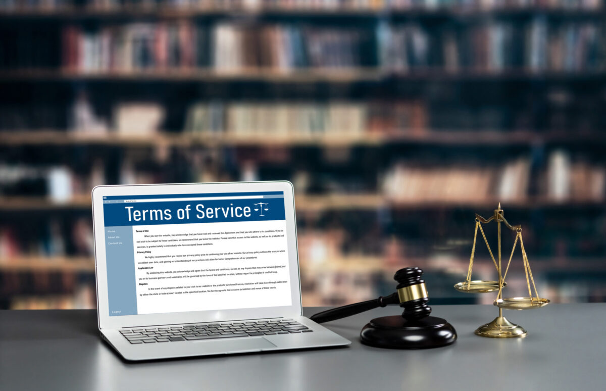 Attorney's office with laptop displaying website terms of service, symbolizing law firm website compliance and security.