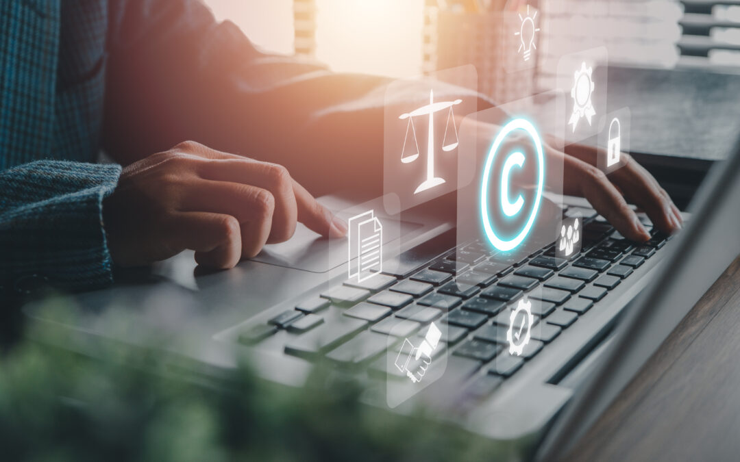 Corporate Attorney using laptop computer on desk with copyright icon background.