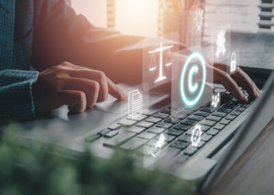 Corporate Attorney using laptop computer on desk with copyright icon background.