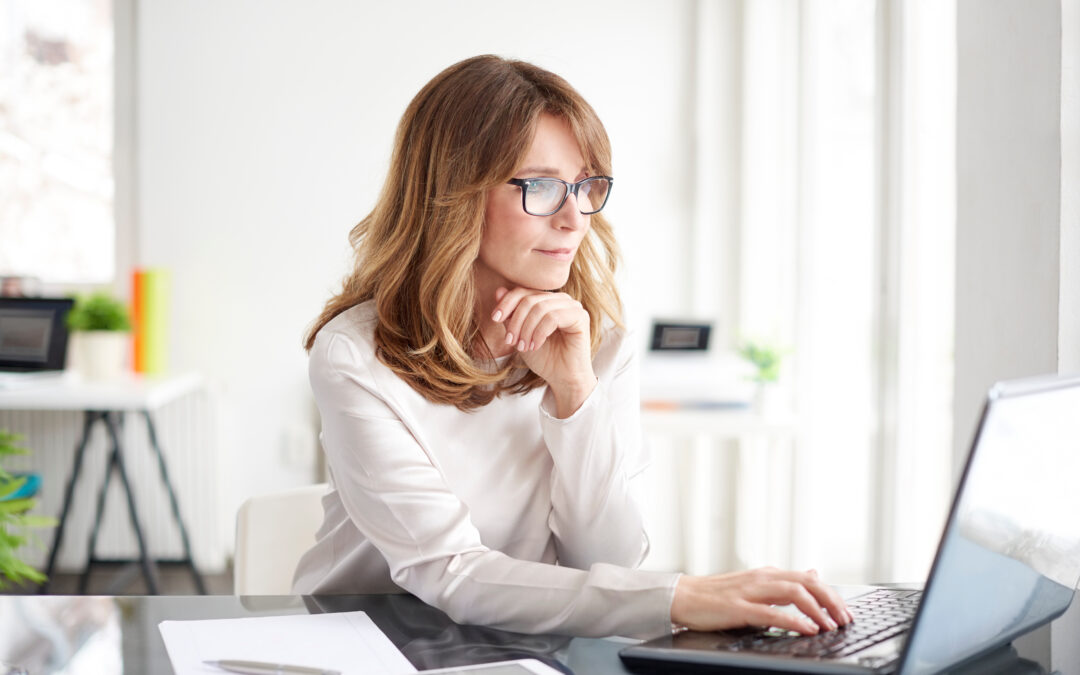 Virtual paralegal working on laptop at desk. 